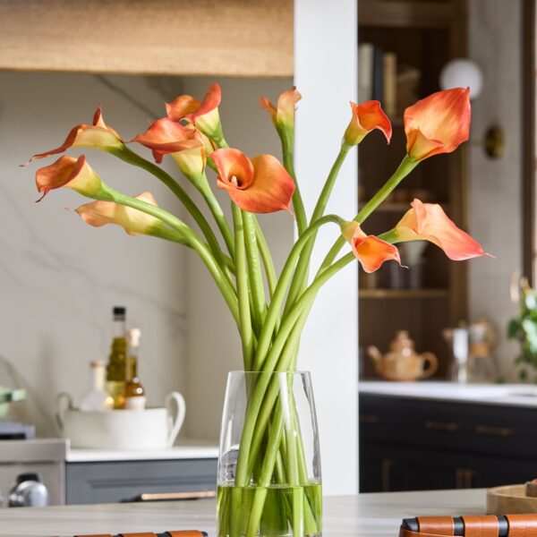 Close-up of vase silhouette detail on this Orange Artificial Calla Lily Arrangement Glass Vase