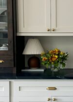 Close-up of vase silhouette detail on this Faux Sunflower and Olive Leaf Glass Vase