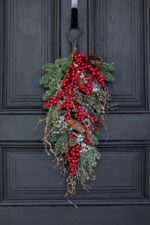 Close-up of swag tail detail on this Waterproof Red Berry, Pinecone Door Holiday Swag