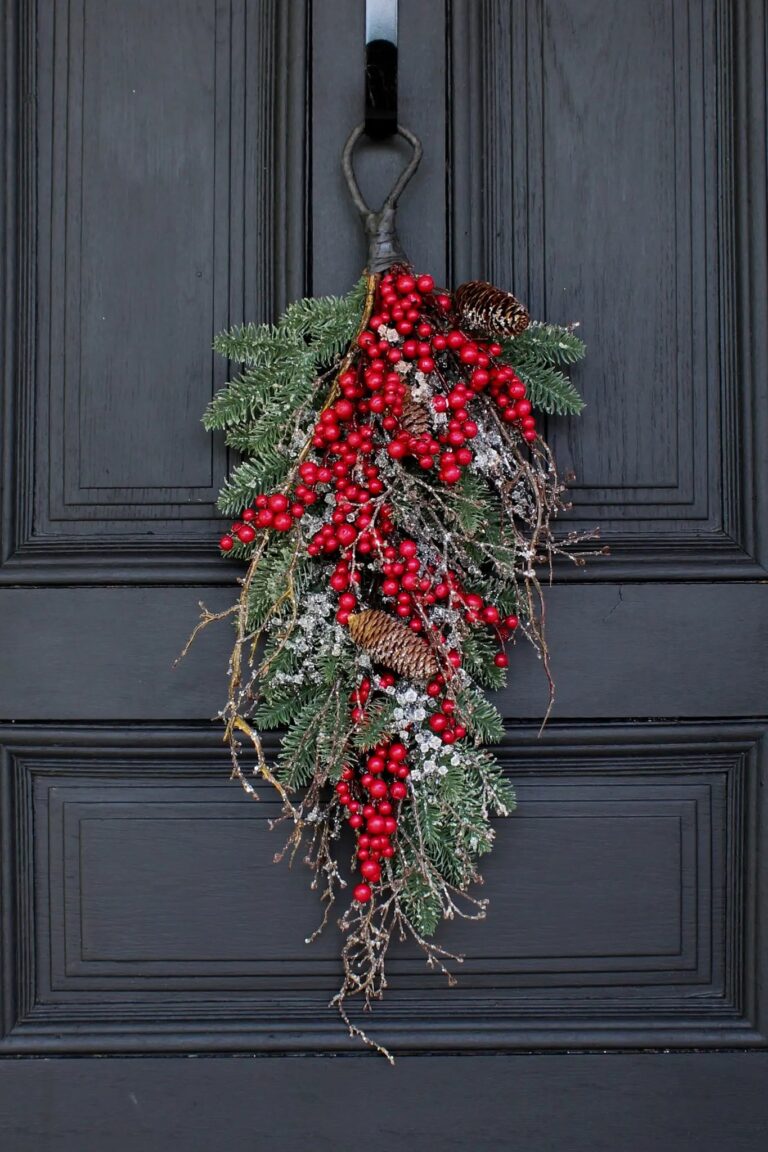 Close-up of swag tail detail on this Waterproof Red Berry, Pinecone Door Holiday Swag