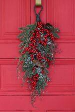 Alternate angle of the Waterproof Red Berry, Pinecone Door Holiday Swag showing full swag shape