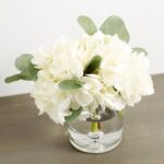 Side view of the White Hydrangea and Eucalyptus Water Glass Cylinder Vase revealing bloom arrangement