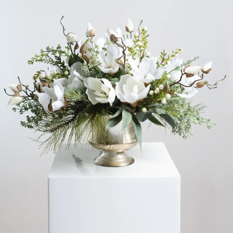 Winter White Magnolia, Pine and Snowberry Christmas Arrangement Centerpiece in Antiqued Silver Metal Urn