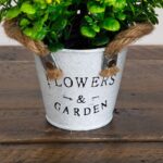 Side view of the 8' Artificial Blooming Plant Garden Planter - Set revealing frond and