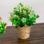 Close-up of branch layering on this 8 inch Artificial Daisy Plant Newspaper Wrapped Planter