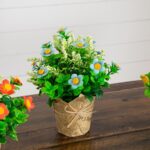Alternate angle of the 8 inch Artificial Daisy Plant Newspaper Wrapped Planter showing full plant