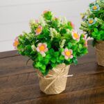 Alternate angle of the 8 inch Artificial Daisy Plant Newspaper Wrapped Planter showing frond and