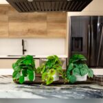 Side view of the 8' Artificial Mixed Greens Ceramic Planter - Set revealing frond and
