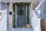 Alternate angle of the Seeding Real Touch Juniper Berry Door Mantle Wreath showing wreath face