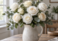 Artificial white, ivory and cream silk roses with eucalyptus in stoneware
