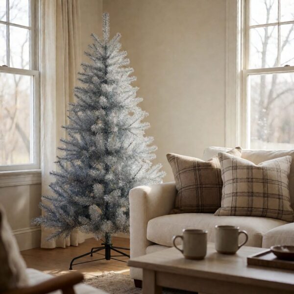 Silverado Slim Flip-Style Artificial Christmas Tree - styled next to a sofa in a bright living room, styled lifestyle scene